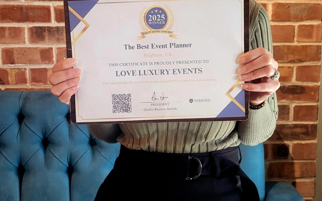 smiling-lady-holding-certificate-in front-brick wall- blue sofa-award