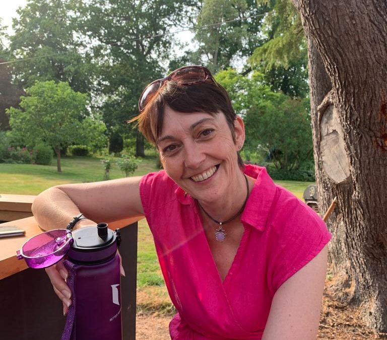 Claire - lady - pink- dress - hot-weather - holding-drink